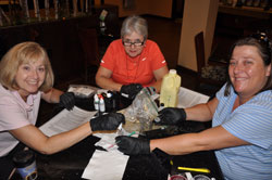 Sharon Butler, Betty Bates and Stephanie Miles test Shoal Creek water in hotel lobby