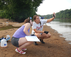 Bethany Todd and Lisa Schwenk assess the results of a water quality test