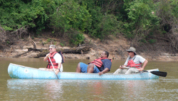 Kevin Faircloth paddles a large canoe with local tour guide, Scott, as Georgia Aquarium videographer Rod Finch records the paddling experience
