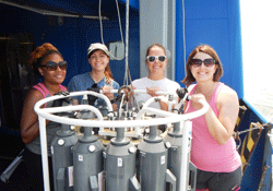 Nakeshia Williams, Kaitlin Dunn, Lisa Schwenk and Bethany Todd use a CTD carousel to collect water samples