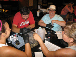 Teachers conduct their first water sample testing of the week in the lobby of the hotel