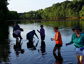 Collecting water samples from the Ocmulgee River prior to setting out in canoes.