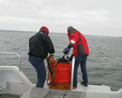 Chris Briand (l) and Todd Recicar (r) lift a barrel of emergency supplies 
