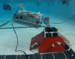 An ROV manipulates a prop, simulating an ocean monitoring device. 