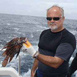 Greg McFall holds lionfish captured in Gray's Reef. 
